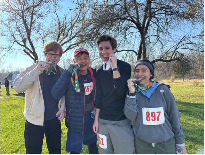 Lab members biting their medals