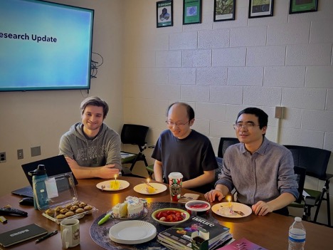 Brandon, Haoyang and Yingbo each have birthday-cake with a candle
